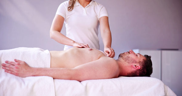 Man Waxing Chest With Wax Strip In Spa